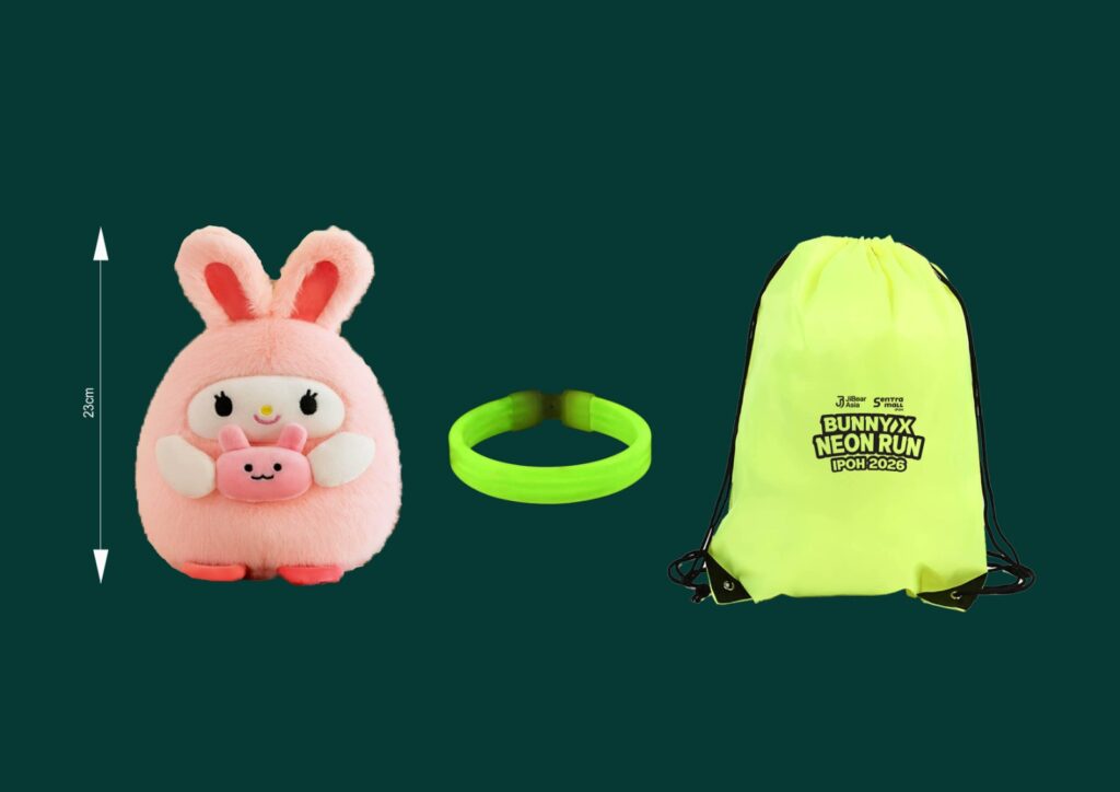 A fluffy pink bunny plush with a small face is next to a neon green bracelet and a yellow drawstring bag labeled "Bunnyx Neon Run Ipoh 2026."