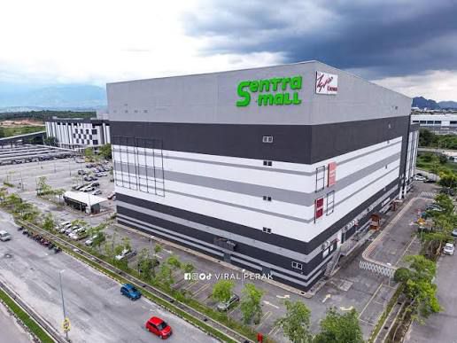 A large, modern shopping mall with "Sentra Mall" sign in green on a gray and white building.